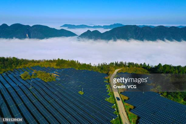 Aerial view of wind turbines and solar panels at a wind and solar hybrid power generation plant on a mountain on October 30, 2023 in Chongqing, China.