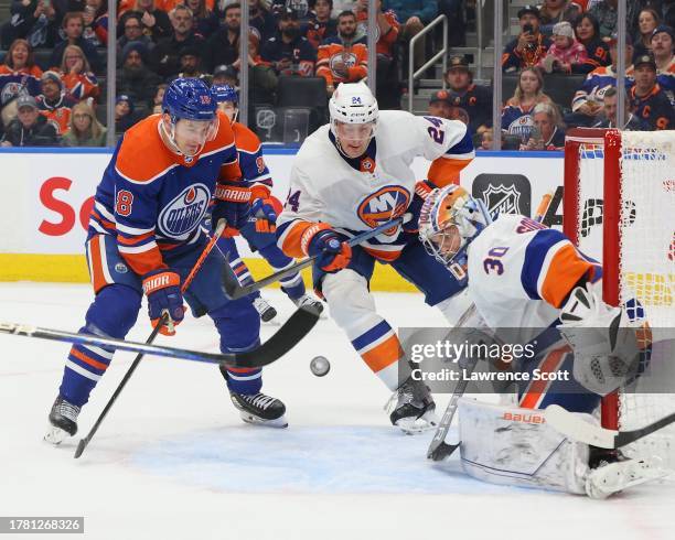 Zach Hyman of the Edmonton Oilers battles for the puck against Scott Mayfield and goaltender Ilya Sorokin of the New York Islanders in the third...