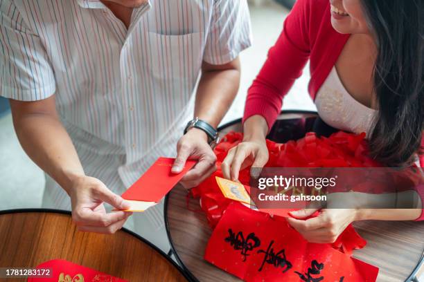 red packet preparation chinese new year - chinese new year red envelope stock pictures, royalty-free photos & images