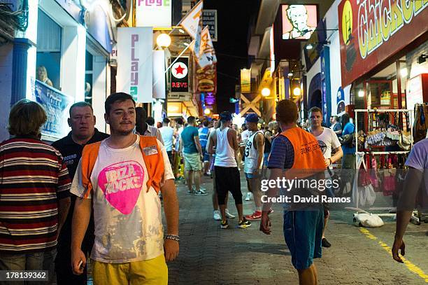 Promotions workers wait for customers at the 'West End' area in San Antonio on August 22, 2013 in Ibiza, Spain. The small island of Ibiza lies within...