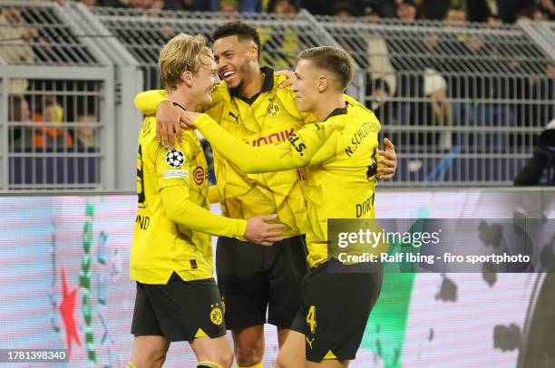 Julian Brandt of Borussia Dortmund celebrates with teammates Felix Nmecha and Nico Schlotterbeck after scoring his teams second goal during the UEFA...