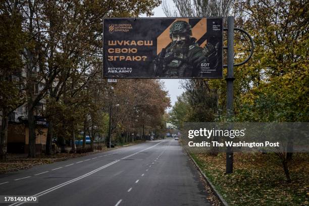 Military recruitment poster reads: 'Looking for your pack?', on a street named Vulytsya Nebesnoyi Sotni is seen in central Kherson on 2nd November...