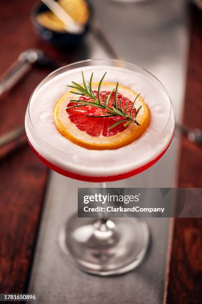 campari sour with grapefruit and rosemary - danish whiskey stock pictures, royalty-free photos & images