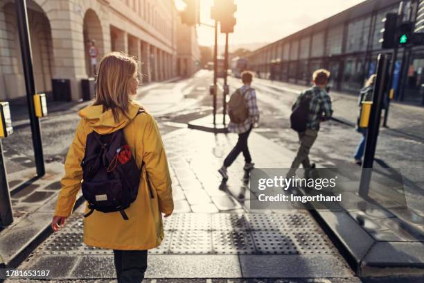 family walking in the town of bath, united kingdom - pedestrian crossing light stock pictures, royalty-free photos & images