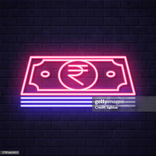 indian rupee banknotes. glowing neon icon on brick wall background - rupee notes stock illustrations