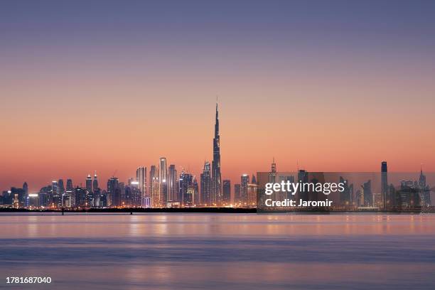 dubai urban skyline at golden dusk - burj khalifa dubai stock pictures, royalty-free photos & images