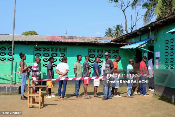 Voters queue at a polling station in Monrovia on November 14, 2023. Liberians began voting on November 14, 2023 to decide whether to hand former...