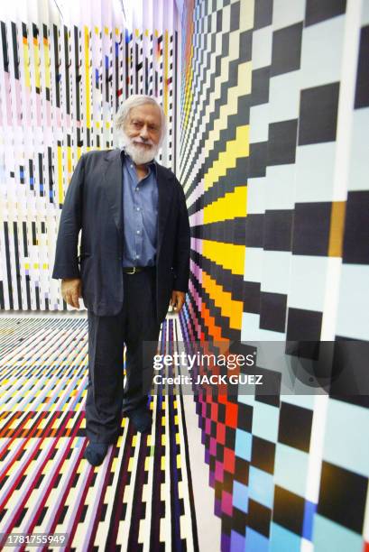 Photo of Agam Yaacov, Israeli artist, poses with one of his works at the Georges Pompidou Art Center 28 June 2003 in Paris where his kinetic...