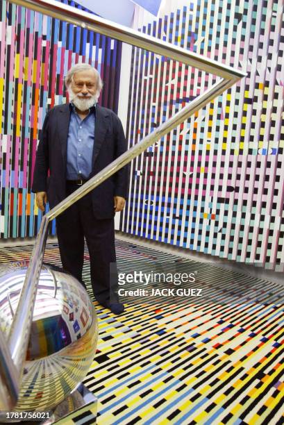 Photo of Agam Yaacov, Israeli artist, posing with one of his pieces at the Georges Pompidou Art Center 28 June 2003 in Paris where his kinetic...