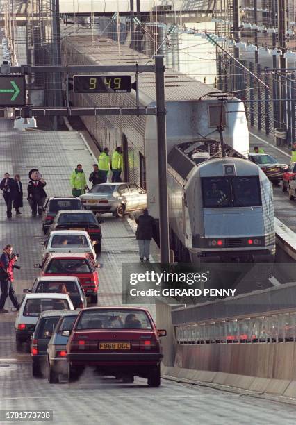 Cars are loaded onto the first shuttle to carry fare-paying passengers 22 December 1994 as the Shuttle service prepared to leave the United Kingdom...