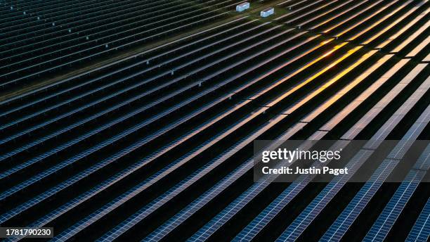 drone view over a field of solar panels at sunset - sky bar stock pictures, royalty-free photos & images