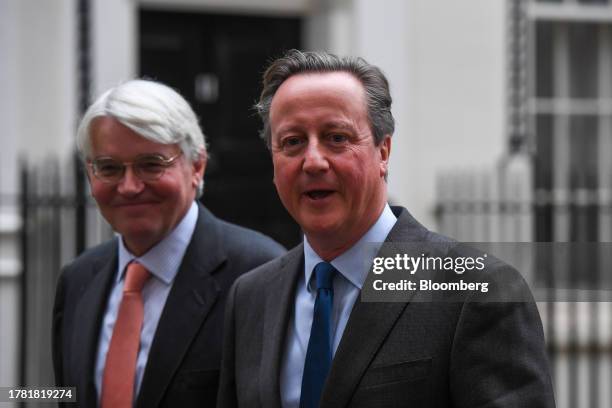 David Cameron, UK foreign secretary, right, and Andrew Mitchell, UK development minister, depart following a meeting of cabinet ministers at 10...