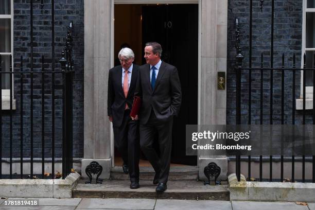 David Cameron, UK foreign secretary, right, and Andrew Mitchell, UK development minister, depart following a meeting of cabinet ministers at 10...