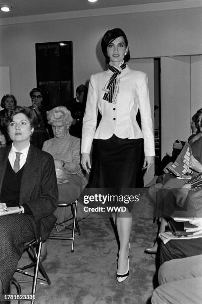 Model Margaret Donohoe presents an ensemble from the spring 1985 ready to wear collection inside of designer Pauline Trigère's New York City showroom.