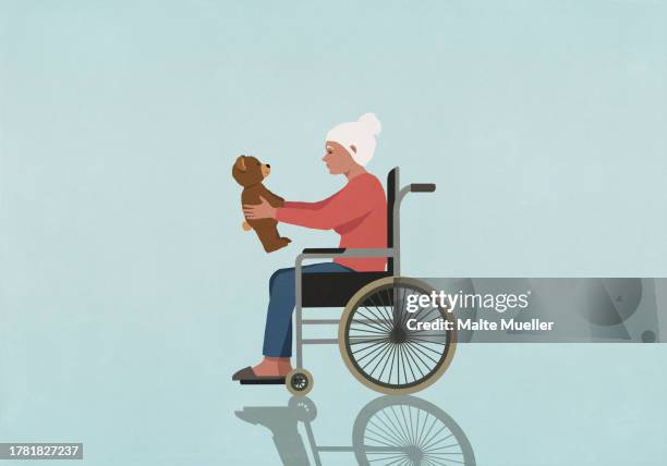 senior woman in wheelchair holding teddy bear on blue background - accessibility stock illustrations