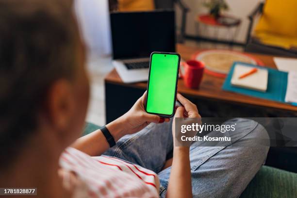 close-up of woman's hands using mobile phone at home for e-banking - online bank statement stock pictures, royalty-free photos & images