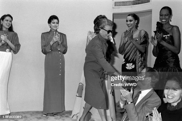 Models applaud while designer Pauline Trigère greets the audience at the end of show.