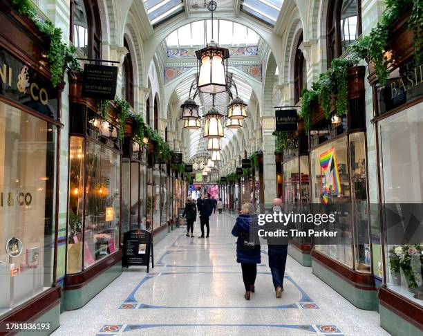 shoppers in an arcade - arcade stock pictures, royalty-free photos & images