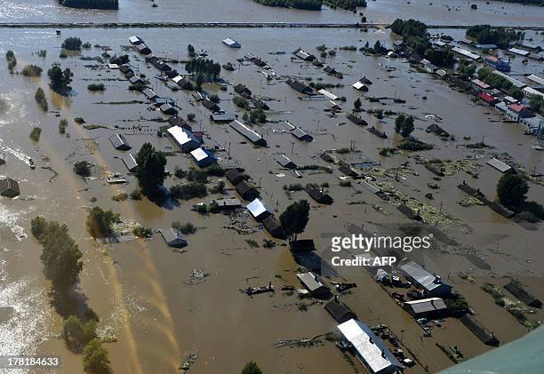 This aerial view picture taken on August 26, 2013 shows houses submerged by the flooded Heilongjiang River, called the Amur River in Russia, in...
