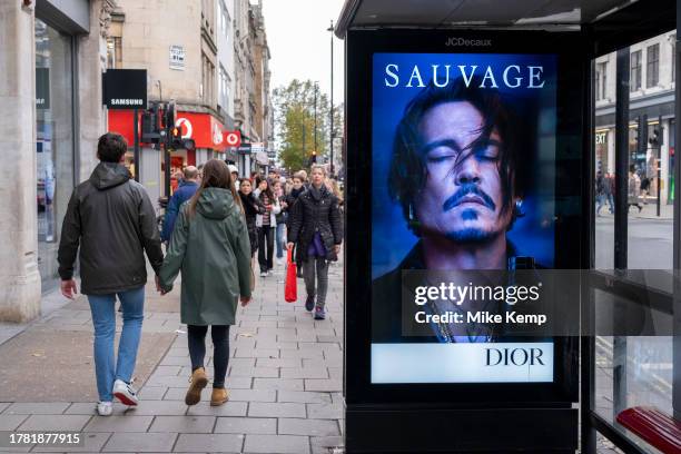 Advertising for the Dior mens fragrance Sauvage featuring American actor and film star Johnny Depp on a bus stop on Oxford Street on 13th November...