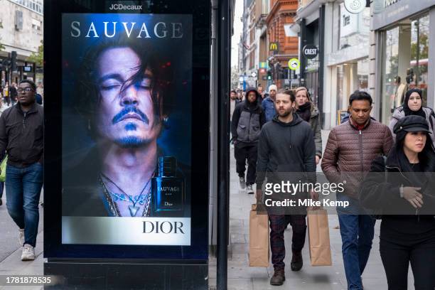 Advertising for the Dior mens fragrance Sauvage featuring American actor and film star Johnny Depp on a bus stop on Oxford Street on 13th November...