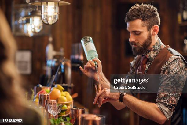 pouring spirits into measures - bartender stock pictures, royalty-free photos & images
