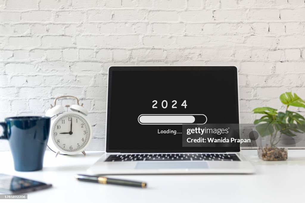 Loading year 2024 for start new business and new life. Equipment working in office with coffee drink. New Year Concept