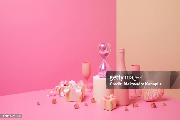 abstract pastel colored 3d scene with pink and beige background, wine bottles,  champagne glasses, sparkling hourglass, christmas gifts and heart ornaments. - champange bottle and valentines day stock pictures, royalty-free photos & images