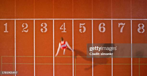male athlete reaching finishing line - athletics track stock pictures, royalty-free photos & images
