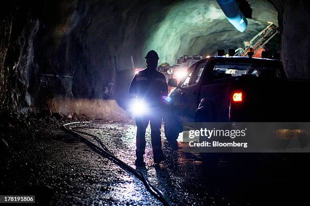 Mine worker observes drilling equipment operating inside the underground iron ore mine run by LKAB, Sweden's state-owned mining company, in Kiruna,...