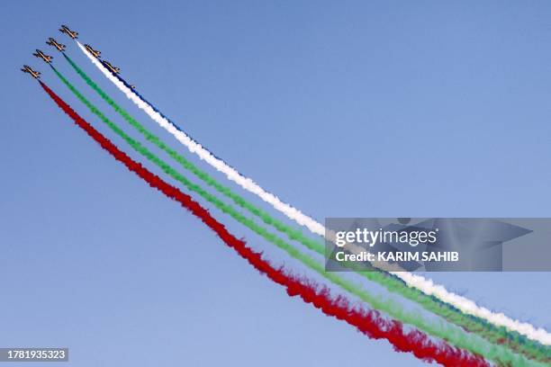 Aermacchi MB-339 trainer aircraft of the Fursan al-Emarat aerobatics team release smoke as they fly over during the 2023 Dubai Airshow at Dubai World...