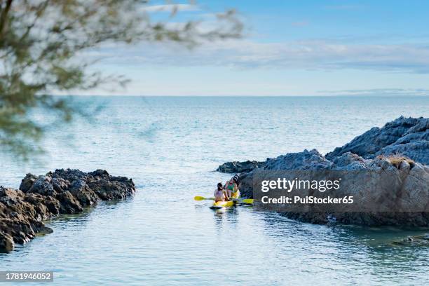 asian athletic woman together with friend on kayak and take a photo. outdoor water sport and travel on summer holiday thailand. - similan islands stock pictures, royalty-free photos & images