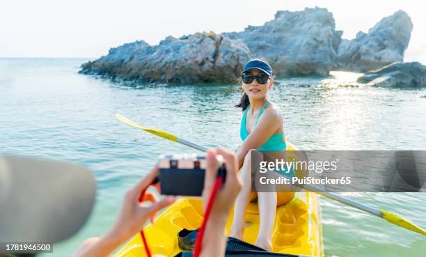 asian athletic woman together with friend on kayak and take a photo. outdoor water sport and travel on summer holiday thailand. - similan islands stock pictures, royalty-free photos & images