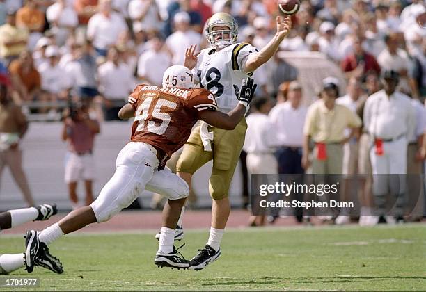 Quarterback Cade McNown of the UCLA Bruins and linebacker Dwight Kirkpatrick of the Texas Longhorns in action during a game at Royal-Memorial Stadium...
