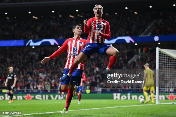 Antoine Griezmann of Atletico Madrid celebrates with teammate Alvaro Morata after scoring the team's third goal during the UEFA Champions League...