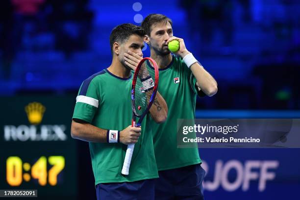 Maximo Gonzalez of Argentina and Andres Molteni of Argentina discuss tactics during their Men's Doubles Round Robin Nitto ATP Finals match against...