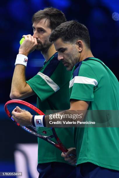 Maximo Gonzalez of Argentina and Andres Molteni of Argentina discuss tactics during their Men's Doubles Round Robin Nitto ATP Finals match against...