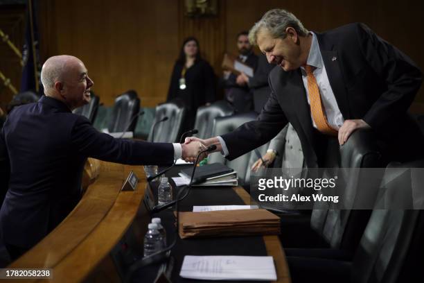 Secretary of Homeland Security Alejandro Mayorkas shakes hands with Sen. John Kennedy prior to a hearing before Senate Appropriations Committee at...