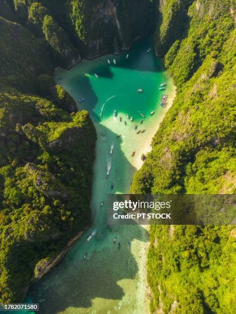 aerial view phi phi ley island with its beautiful maya bay and pileh lagoon in the andaman sea, where many tourists come to krabi, thailand. - phuket beach stock-fotos und bilder