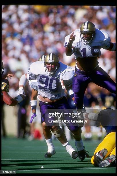 Defensive tackle Steve Emtman of the Washington Huskies tries to break through the line during a game against the California Bears at Memorial...