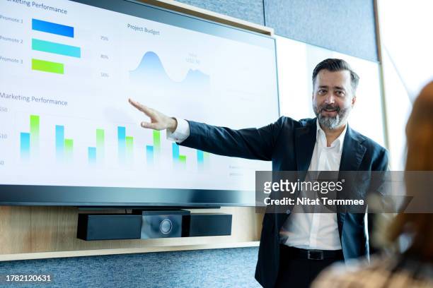great discussions to create great solutions for your business management strategy. business executive giving a presentation on marketing performance info-graphic data to make strategy planning at a board meeting in a business office. - great customer service stock pictures, royalty-free photos & images