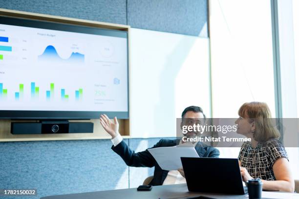 review your business performance to determine business competitive. business executive discussing on business performance review over an info-graphic data in a conference meeting room of business office. - deadline stock pictures, royalty-free photos & images
