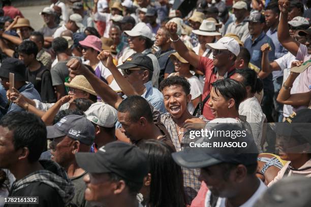 Supporters cheer as members of the collective of opposition candidates march through the streets of Analamahitsy district to protest against the...