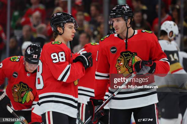 Connor Bedard and Taylor Raddysh of the Chicago Blackhawks warms up prior to the game against the Vegas Golden Knights at the United Center on...