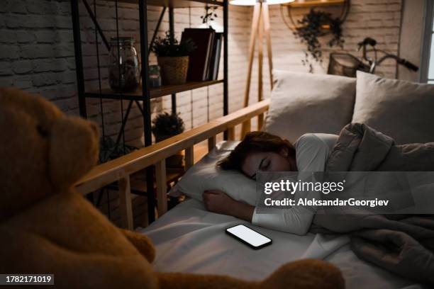 ambiental lights and sounds from smartphone helping female sleep - television static stock pictures, royalty-free photos & images