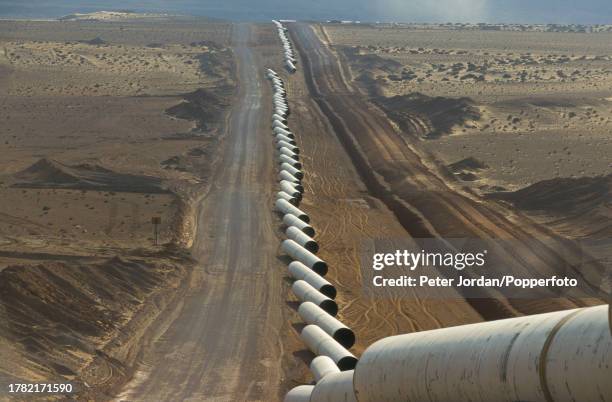 View of sections of pipework waiting to be joined together, sealed and buried during construction of the Maghreb-Europe Gas Pipeline in the desert...
