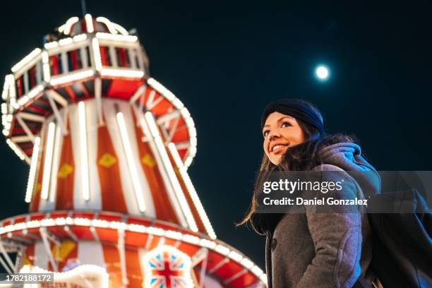 happy young woman in amusement park at night - 2018 lunar stock pictures, royalty-free photos & images