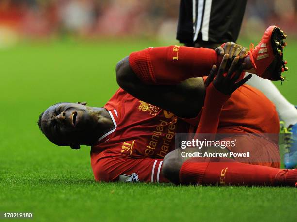 Aly Cissokho of Liverpool is injured in play during the Capital One Cup second round match between Liverpool and Notts County at Anfield on August...