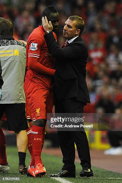 Aly Cissokho of Liverpool is spoken to by manager Brendan Rodgers as he is substituted off the pitch after suffering an injury during the Capital One...