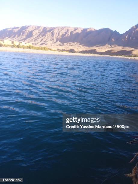 scenic view of sea and mountains against clear sky,province de midelt,morocco - midelt photos et images de collection